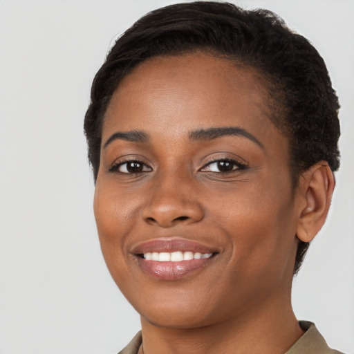 Joyful black young-adult female with short  brown hair and brown eyes