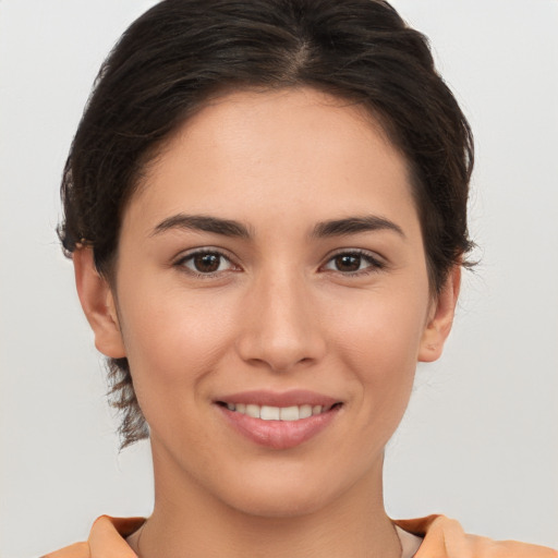 Joyful white young-adult female with short  brown hair and brown eyes