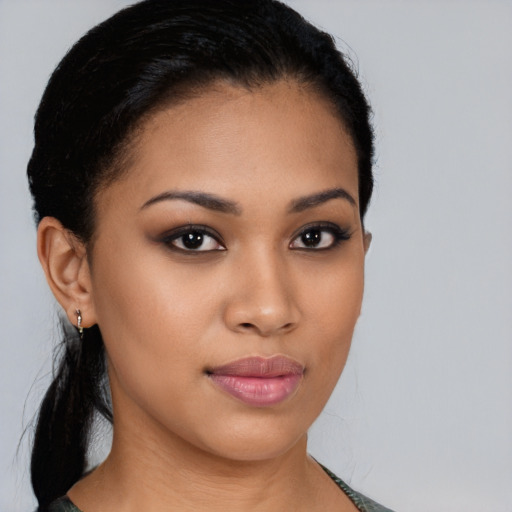 Joyful latino young-adult female with short  black hair and brown eyes