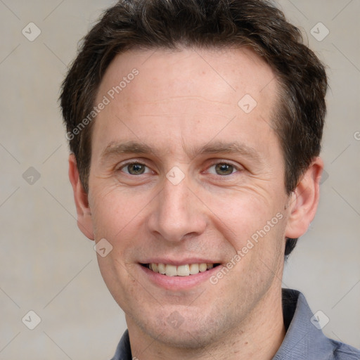 Joyful white adult male with short  brown hair and grey eyes