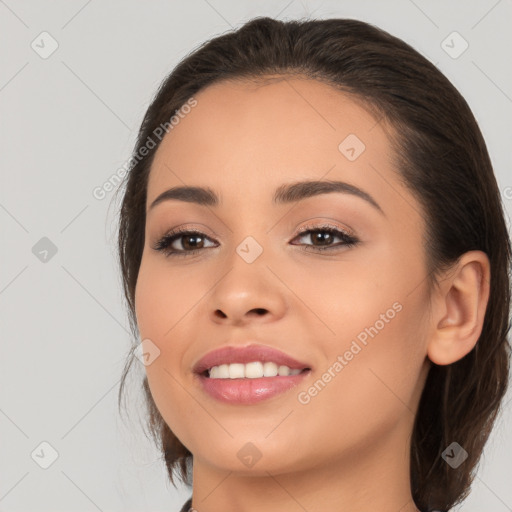 Joyful white young-adult female with long  brown hair and brown eyes