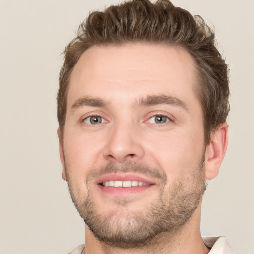 Joyful white young-adult male with short  brown hair and brown eyes