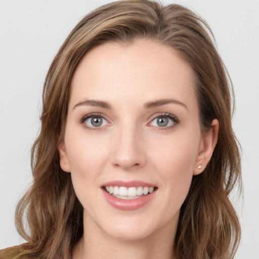 Joyful white young-adult female with long  brown hair and green eyes