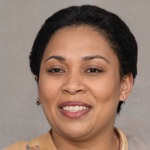 Joyful latino adult female with short  brown hair and brown eyes