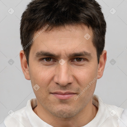 Joyful white adult male with short  brown hair and brown eyes