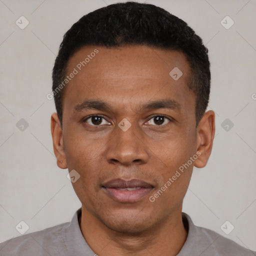 Joyful black young-adult male with short  black hair and brown eyes