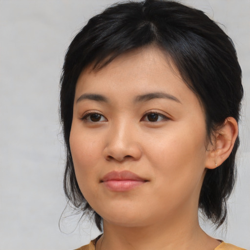 Joyful asian young-adult female with medium  black hair and brown eyes
