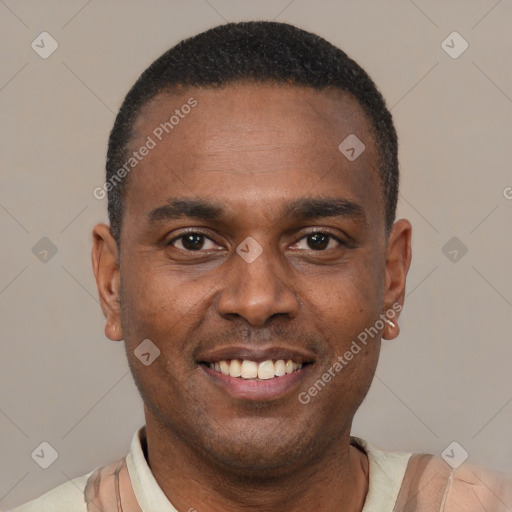 Joyful black adult male with short  brown hair and brown eyes