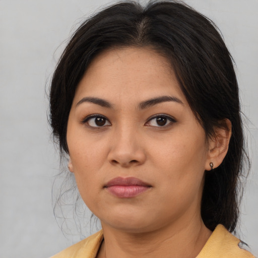 Joyful asian young-adult female with medium  brown hair and brown eyes