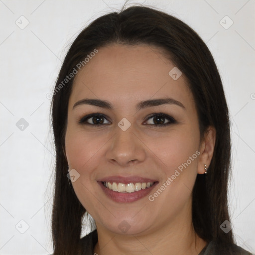 Joyful white young-adult female with long  brown hair and brown eyes