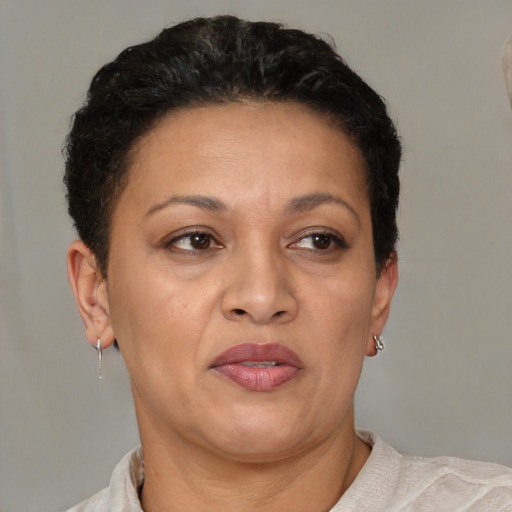 Joyful latino adult female with short  brown hair and brown eyes