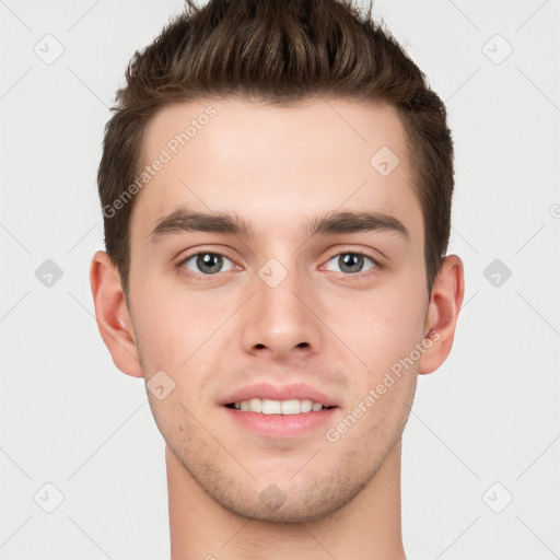 Joyful white young-adult male with short  brown hair and grey eyes