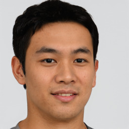 Joyful asian young-adult male with short  black hair and brown eyes