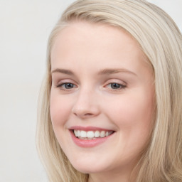 Joyful white young-adult female with long  brown hair and blue eyes