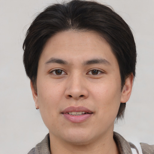 Joyful asian young-adult male with medium  brown hair and brown eyes