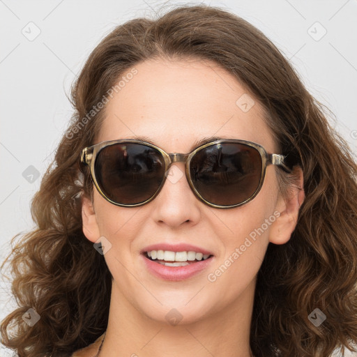 Joyful white young-adult female with long  brown hair and blue eyes