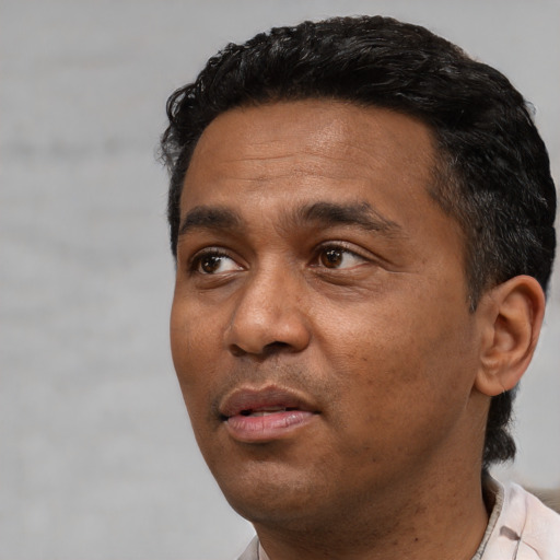 Neutral black adult male with short  black hair and brown eyes