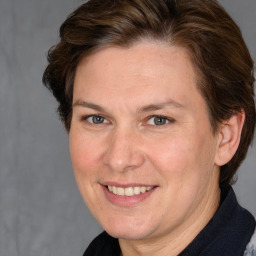 Joyful white adult female with medium  brown hair and brown eyes