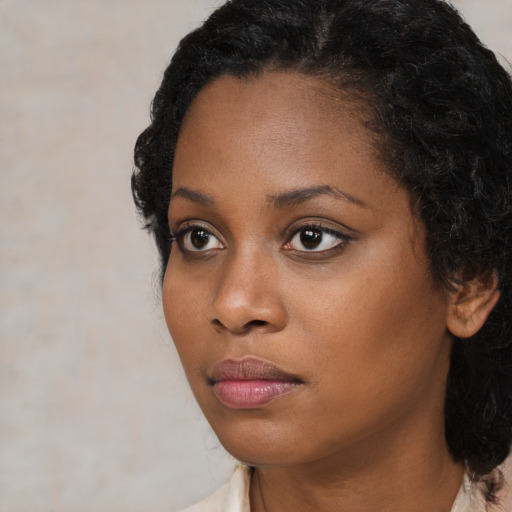 Neutral black young-adult female with medium  black hair and brown eyes