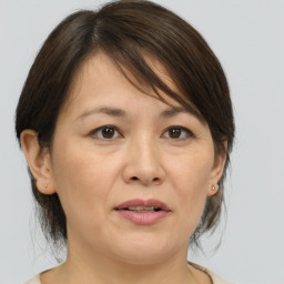 Joyful white adult female with medium  brown hair and brown eyes