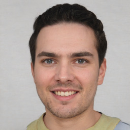 Joyful white young-adult male with short  black hair and brown eyes