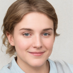 Joyful white young-adult female with medium  brown hair and blue eyes