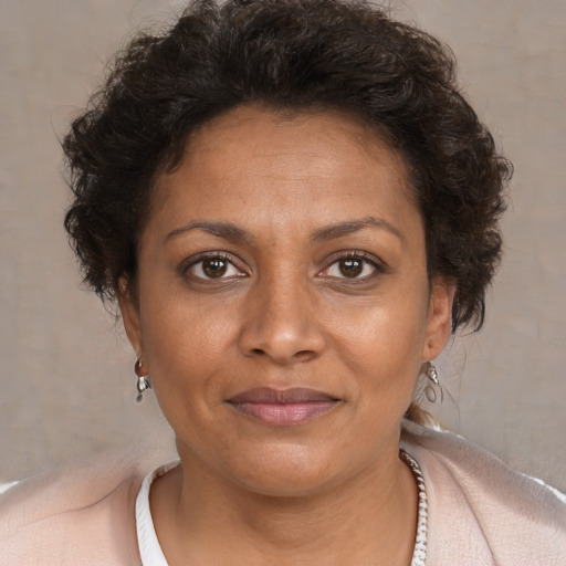 Joyful black adult female with short  brown hair and brown eyes