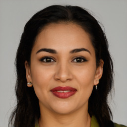 Joyful latino young-adult female with long  brown hair and brown eyes