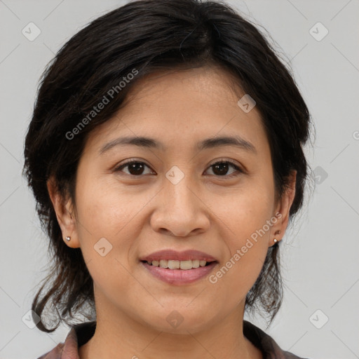 Joyful asian adult female with medium  brown hair and brown eyes