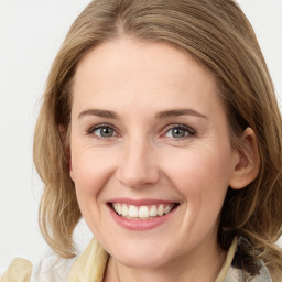 Joyful white young-adult female with medium  brown hair and blue eyes