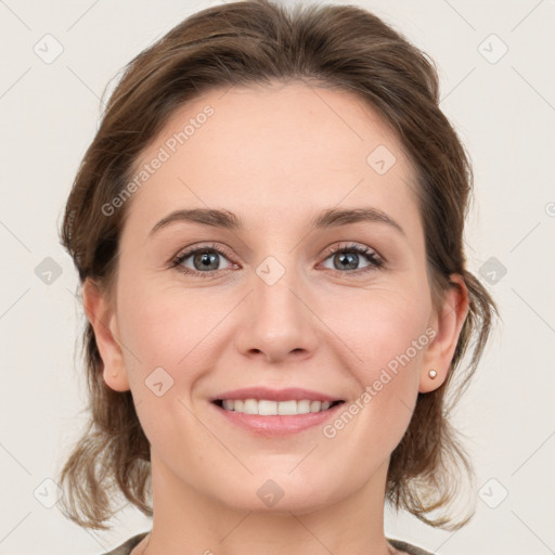 Joyful white young-adult female with medium  brown hair and grey eyes