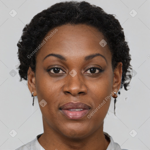 Joyful black adult female with short  brown hair and brown eyes