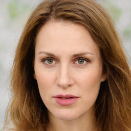 Joyful white young-adult female with long  brown hair and green eyes