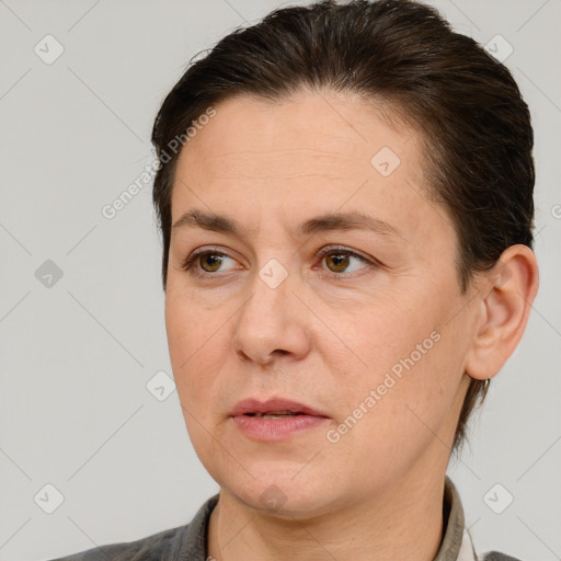 Joyful white adult female with medium  brown hair and brown eyes