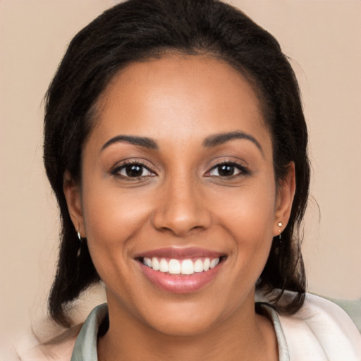 Joyful latino young-adult female with long  black hair and brown eyes