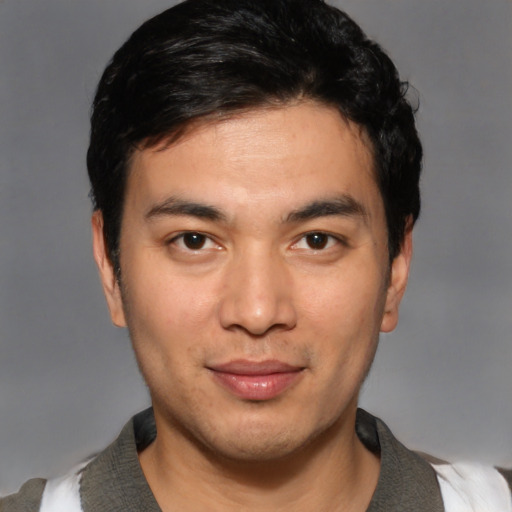 Joyful white young-adult male with short  black hair and brown eyes