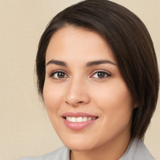 Joyful white young-adult female with medium  brown hair and brown eyes