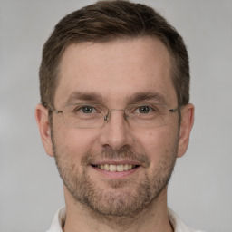 Joyful white adult male with short  brown hair and grey eyes