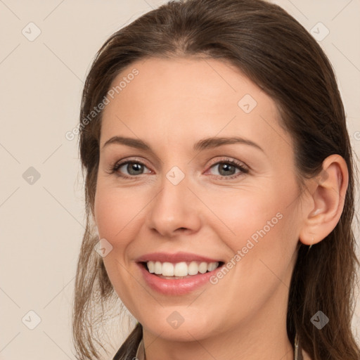 Joyful white young-adult female with medium  brown hair and grey eyes