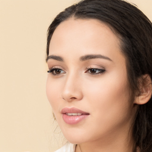 Joyful white young-adult female with long  black hair and brown eyes