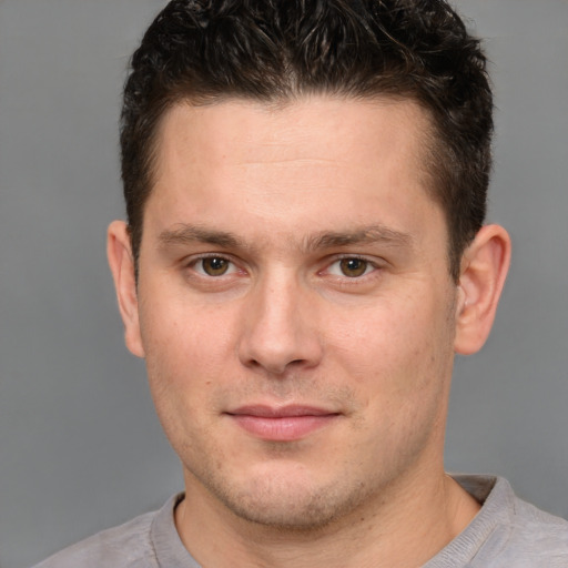 Joyful white young-adult male with short  brown hair and brown eyes