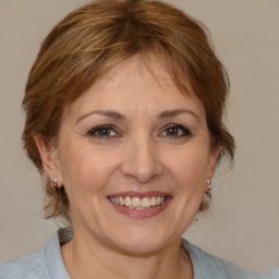 Joyful white adult female with medium  brown hair and brown eyes