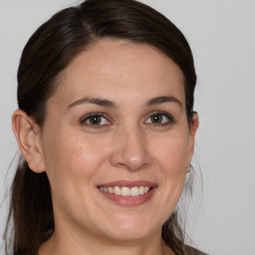 Joyful white young-adult female with medium  brown hair and brown eyes