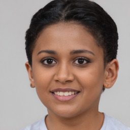 Joyful latino young-adult female with short  brown hair and brown eyes