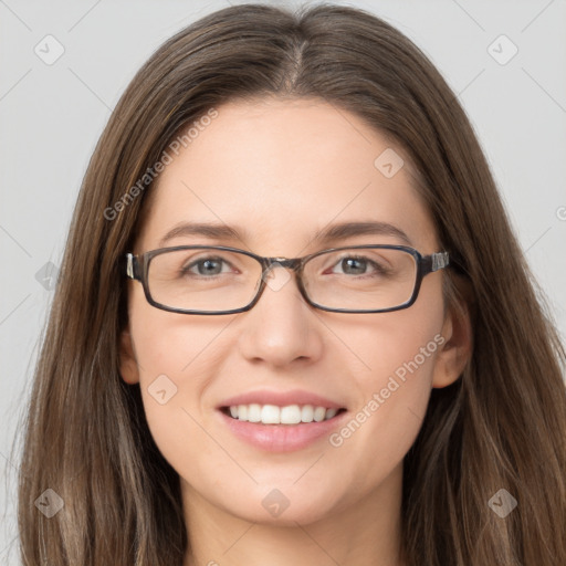 Joyful white young-adult female with long  brown hair and grey eyes