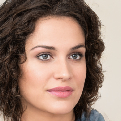 Joyful white young-adult female with medium  brown hair and green eyes