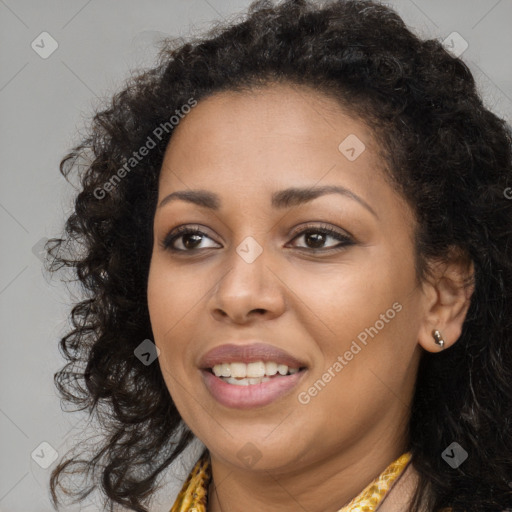 Joyful black young-adult female with long  brown hair and brown eyes