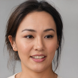 Joyful asian young-adult female with medium  brown hair and brown eyes