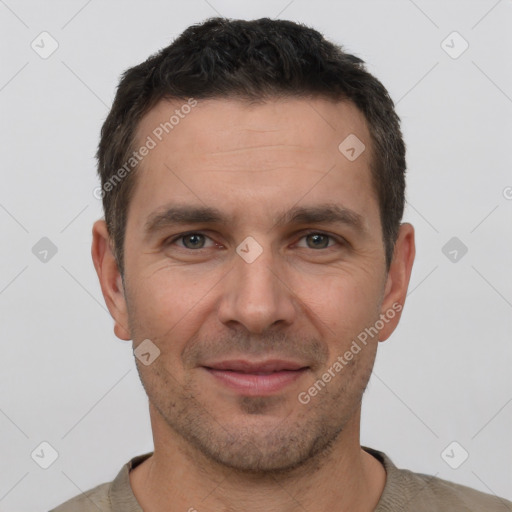 Joyful white adult male with short  brown hair and brown eyes