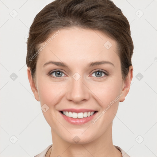 Joyful white young-adult female with short  brown hair and grey eyes